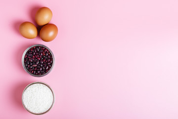 Obraz na płótnie Canvas Eggs, rice, beans on a pink background. Concept of food delivery and food donation during quarantine isolation during the coronavirus pandemic. online grocery shopping. copy space