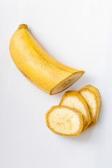 slices of a yellow banana in a cut on a white background macro shot