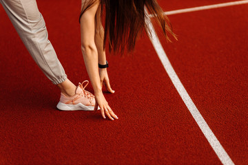 Fitness sport girl in fashion sportswear doing yoga fitness exercise on the stadium, outdoor sports