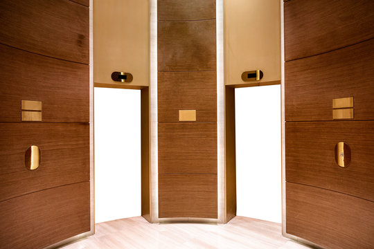 White blank elevator doors on wooden room