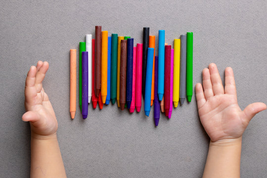 Educational development for children. Crayons on paper, flat lay