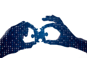 Silhouette of a hands holding a jigsaw puzzle piece with binary background