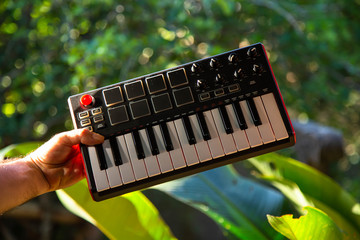Holding midi keyboard in a garden