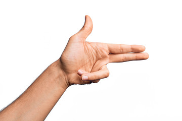Hand of caucasian young man showing fingers over isolated white background gesturing fire gun weapon with fingers, aiming shoot symbol