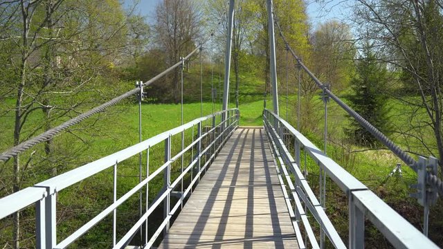 Suspension bridge over the river in spring