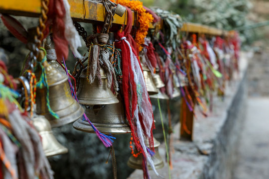 metal bells hang on chains in a Hindu temple. Dakshinkali Temple in Pharping, Nepal.