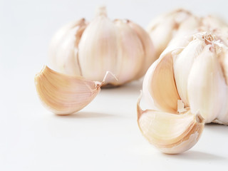 Macro stack garlic cloves on white background, fresh garlic  improves Cholesterol Levels, Which May Lower the Risk of Heart Disease. Health care concept