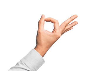 Hand of caucasian young man showing fingers over isolated white background gesturing approval...