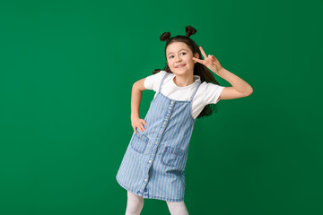 Cute dancing girl on color background