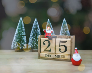 Santa sitting on block dated 25 December waiting to Christmas and New Year, Happy concept