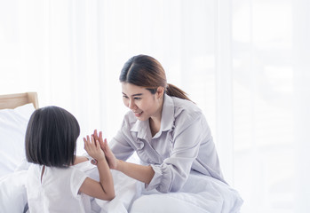 Obraz premium Mother playing with her sister in bedroom