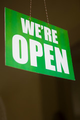 Open sign on the glass of the door at store