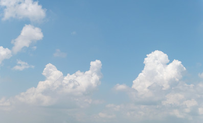 Naklejka na ściany i meble Blue sky with white soft clouds. Simple outdoor sky background.