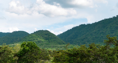 Green mountains and beautiful sky clouds under blue sky. Outdoor landscape for background.