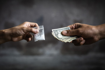Hand of addict man with money buying dose of cocaine or heroine, close up of addict buying dose from drug dealer, drug trafficking, crime, addiction and sale concept, - obrazy, fototapety, plakaty