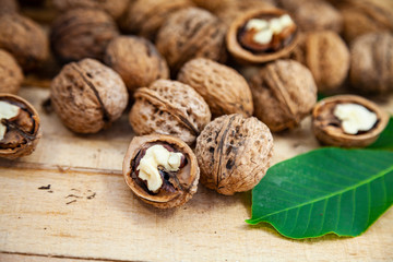 Walnuts and leaves on a  table.