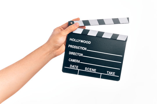 Hand of caucasian young filmmaker man holding clapboard over isolated white background