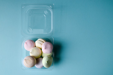 Top view of pastel colored marshmallow on a blue pink background. Minimalism photo for your design