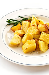 Fried baked potatoes with rosemary on a white plate