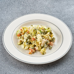 Russian salad Olivier on a white plate.