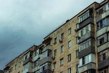 Fototapeta na wymiar Typical Russian residential high-rise old panel building in cloudy weather.