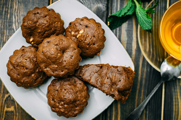 homemade cakes, chocolate muffins with mint and tea with lemon