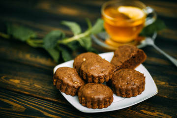 homemade cakes, chocolate muffins with mint and tea with lemon