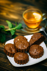 homemade cakes, chocolate muffins with mint and tea with lemon