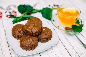 homemade cakes, chocolate muffins with mint and tea with lemon