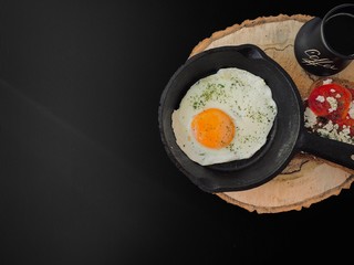 Fried eggs on a wooden background, delicious breakfast