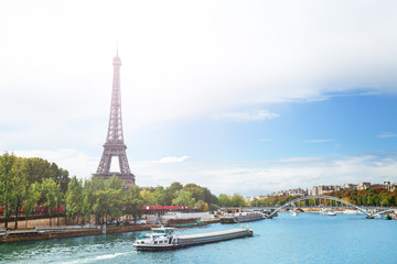 View over Seine river on Eifel tower with boats passing and Passerelle Debilly during summer, Paris...