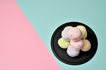 Top view of pastel colored marshmallow on a blue pink background. Minimalism photo for your design