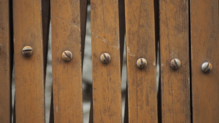 Close up and zoomed steel bolts and wood texture background