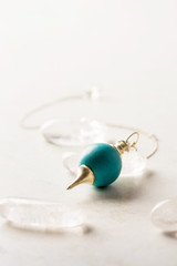 turquoise pendulum on white background