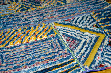 Chenille patterns on a rug made from jeans and fabric.