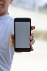 Vertical photo of a man showing a mobile