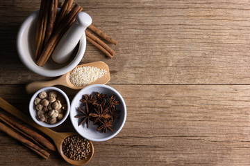 Variety of spices and natural herbs supplements health food on rustic table.