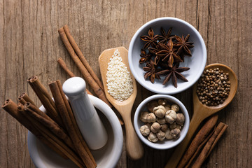 Variety of spices and natural herbs supplements health food on rustic table.