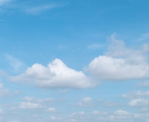 Fototapeta na wymiar Blue sky with white soft clouds. Simple outdoor sky background.