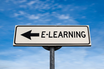 White sign with arrow - E-learning. Direction sign. Crossroads Road Sign, arrow on blue sky background. Arrows on a pole pointing in one direction. Learning in that direction. Never stop learning.