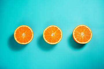 Fresh orange on the light turquoise background. View from above. Place for text.
