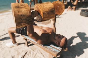 Man training in Eco gym on the beach