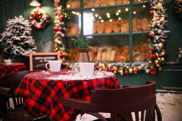 Served table in modern outdoor cafe. Christmas celebration