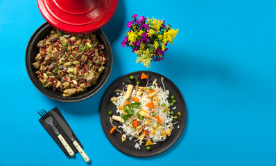 Traditional morroccon cuisine: Tagine/Tajine food. Dish made with lamb, chicken, pomegranate and almond served with carrot, corn, chick pea and potato garnished rice.