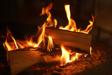 Fireplace with burning wood, closeup view. Winter vacation