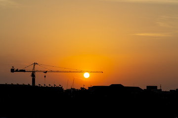 Naklejka premium Silhouette of unde construction town when sun set shows travel scene