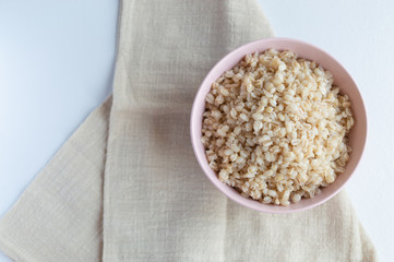 National Russian food pearl barley porridge in a pink bowl
dark key