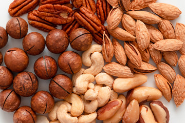 Top view of assorted nuts on gray background with copy space