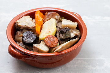 typical portuguese dish boiled meat, smoked sausages, vegetables and rice on white plate
