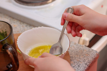 Girl stirs the sauce. Cooking at home.